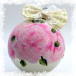 Christmas ornament with pink floral design and cream lace bow